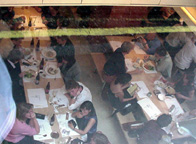 looking down into restaurant through street-level window