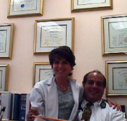 dr gigi diamond + her husband dr anthony botti in front of their numerous degrees